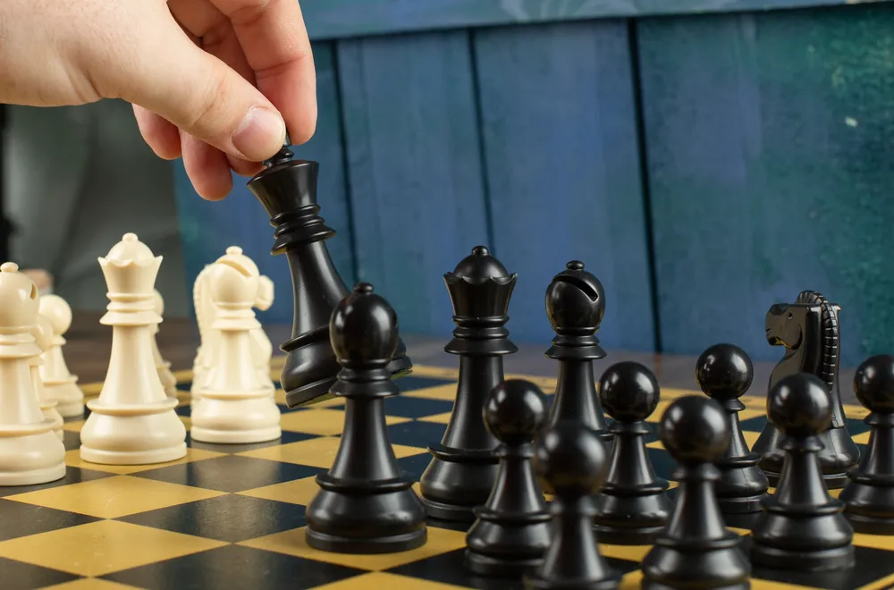 player-playing-black-figures-chessboard
